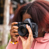 Person holding a Canon EOS 3 Film Camera with a blurred natural background