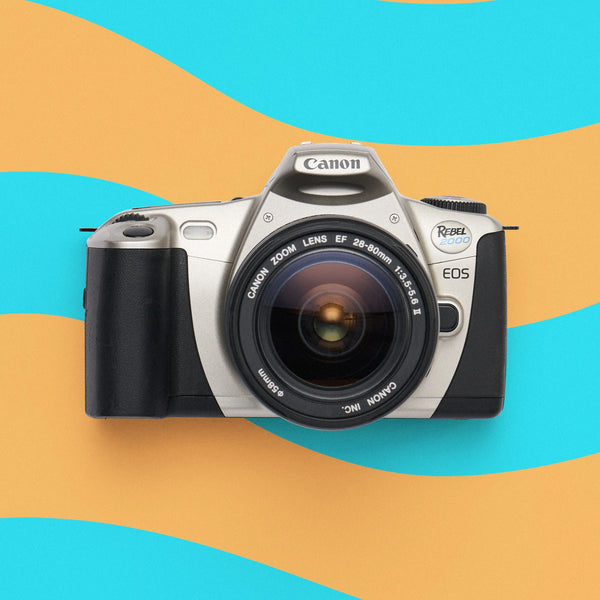 Canon EOS Rebel 2000 film camera on a colorful abstract background
