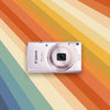 Canon Powershot ELPH 135 on a colorful striped background