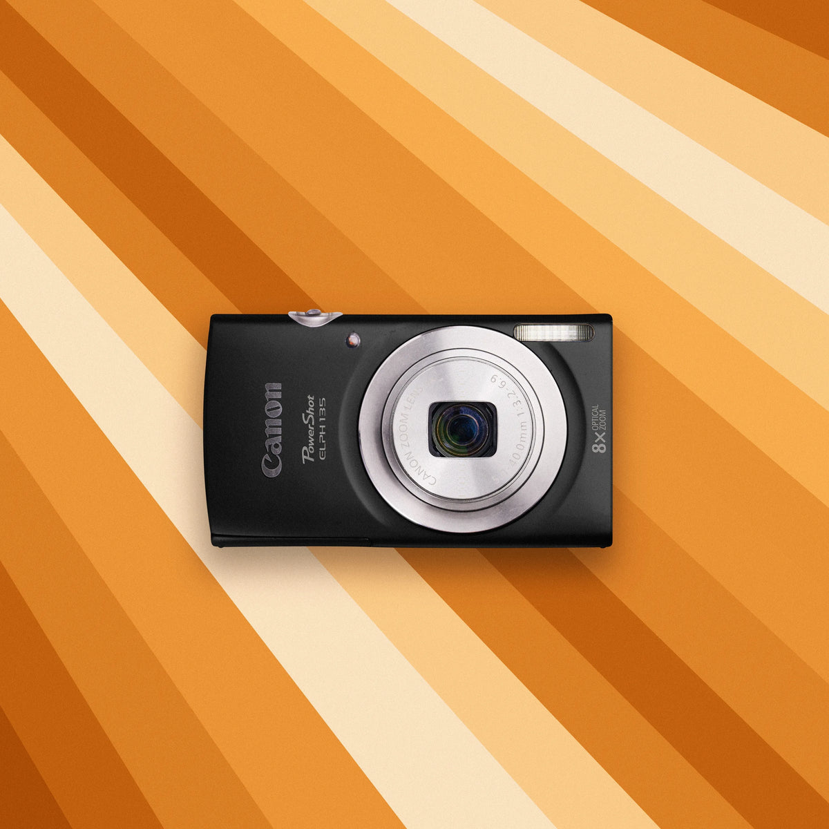 Canon Powershot ELPH 135 on an orange and beige striped background