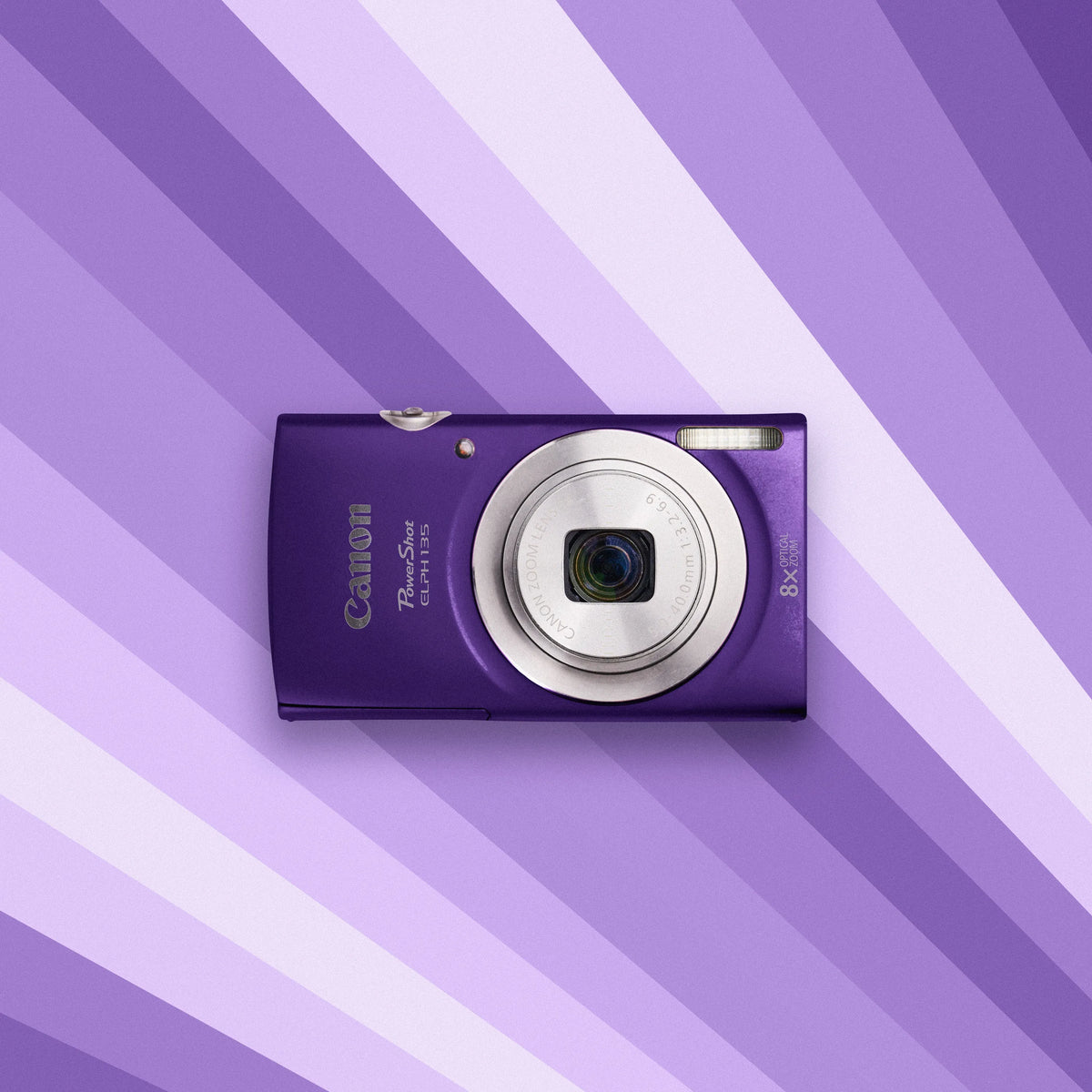 Purple Canon Canon Powershot ELPH 135 on a purple and white striped background