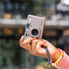 Person holding a Contax T3 35mm Point and Shoot Camera camera with a blurred background