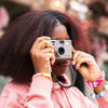 Person holding a Contax T3 35mm Point and Shoot Camera with a blurred background