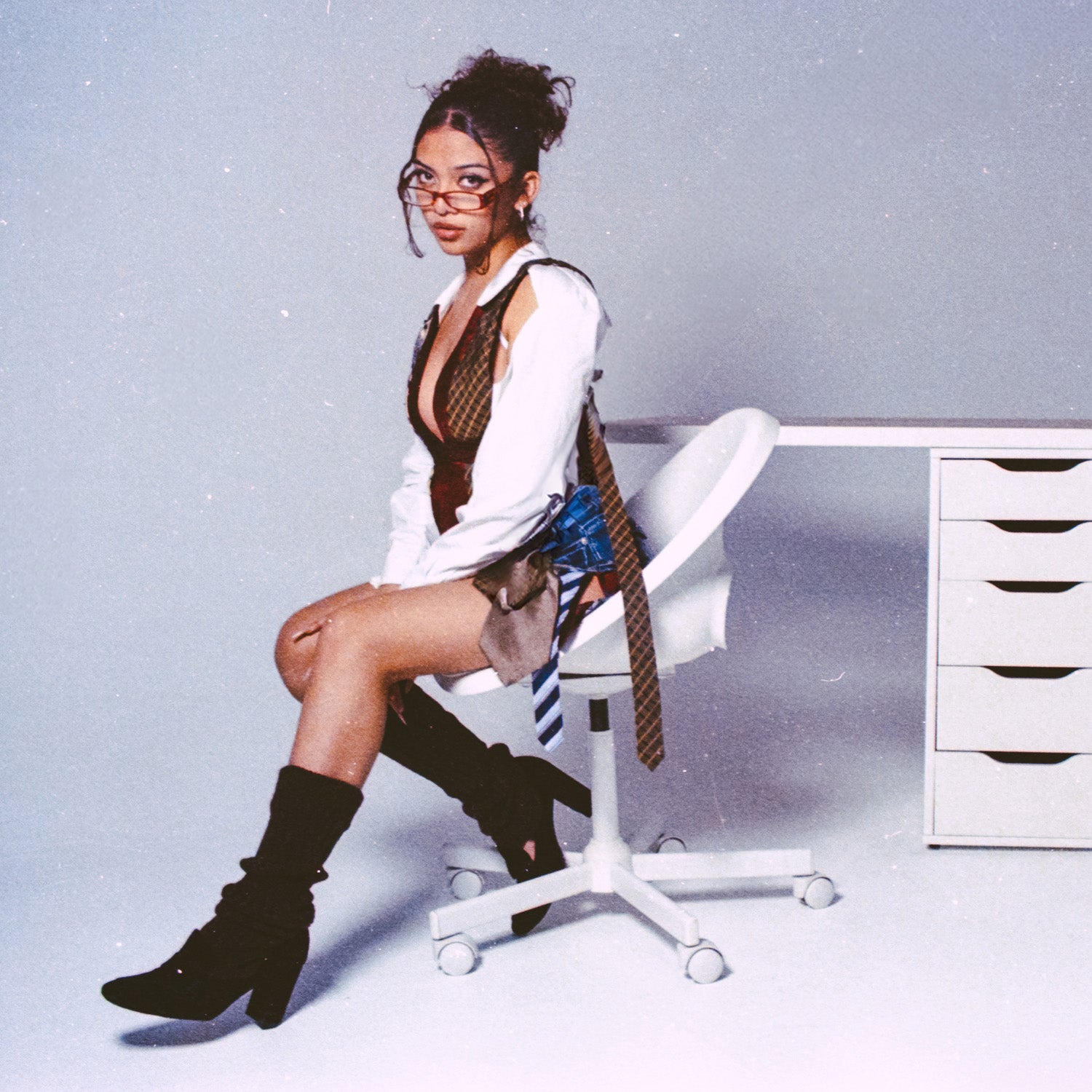 Person sitting on a white office chair in a minimalistic room taken with a Nikon F2 35mm Film Camera