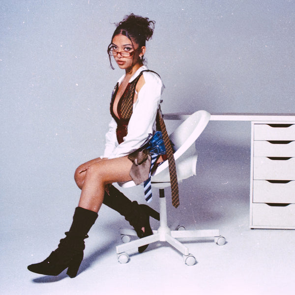 Person sitting on a white office chair in a minimalistic room taken with a Nikon F2 35mm Film Camera