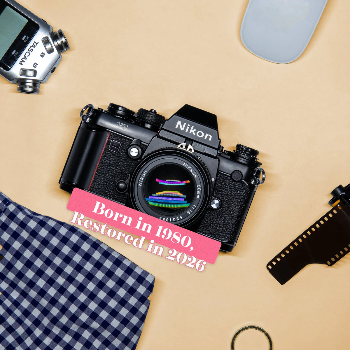 Nikon F3 35mm Film Camera with text 'Born in 1980, Restored in 2026' on a beige background