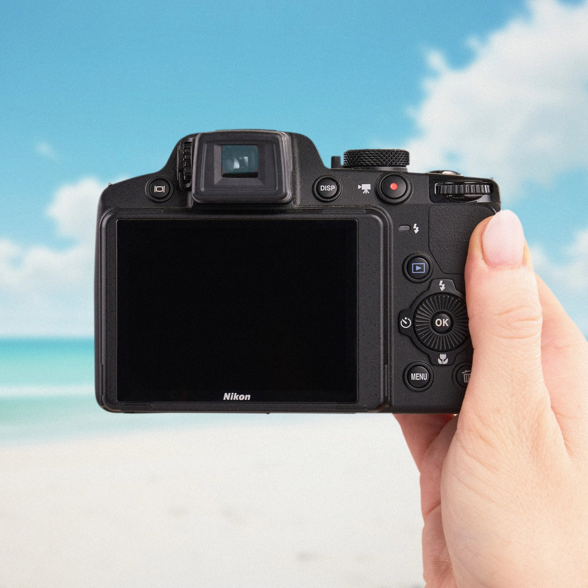 Back view of a Nikon COOLPIX P510 showing its LCD screen and controls at the beach