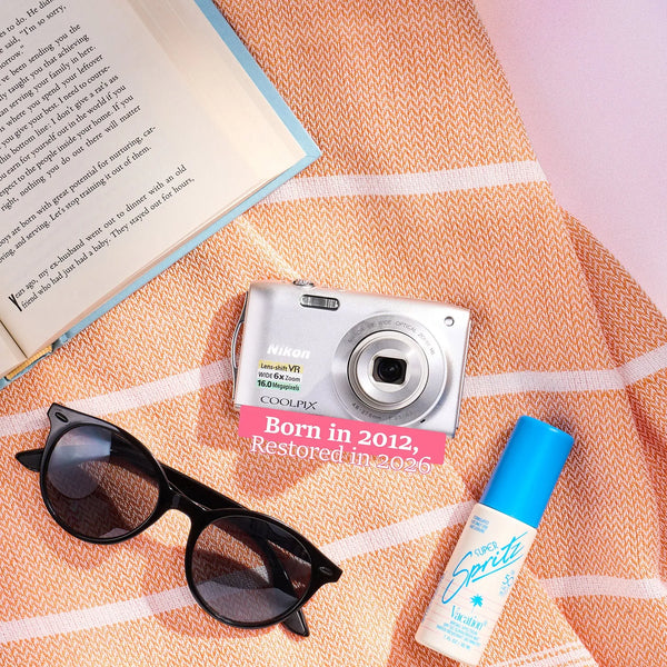 Restored Nikon COOLPIX S3300 styled with summer accessories and text reading “Born in 2012, Restored in 2026”