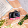 Restored Canon PowerShot SX530 HS styled with a book and sunglasses, labeled Born in 2015, Restored in 2026