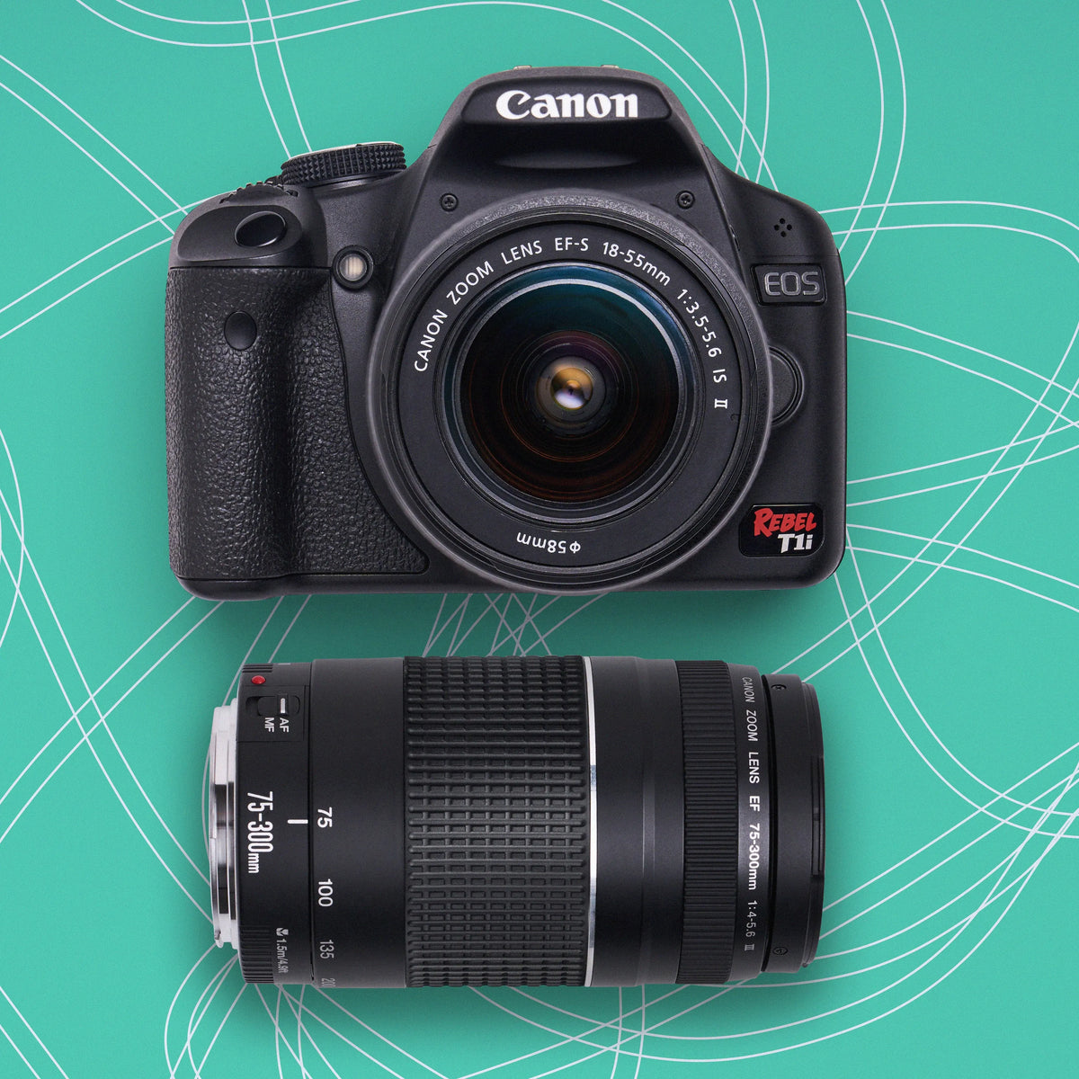 Canon Rebel T1i DSLR camera with 18–55mm and 75–300mm lenses on a teal patterned background