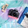 Restored Canon Rebel T1i styled with colorful accessories, labeled Born in 2009, Restored in 2026