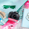 Restored Canon Rebel T2i styled with colorful accessories, labeled Born in 2010, Restored in 2026