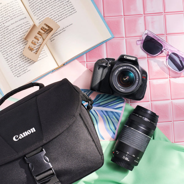 Canon Rebel T3i dual-lens kit with camera bag, DSLR body, two lenses, book and sunglasses