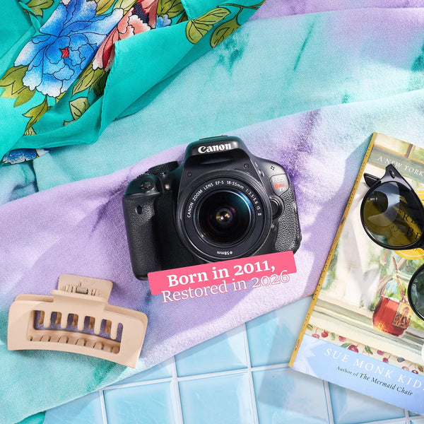 Restored Canon Rebel T3i styled with colorful accessories, labeled Born in 2011, Restored in 2026