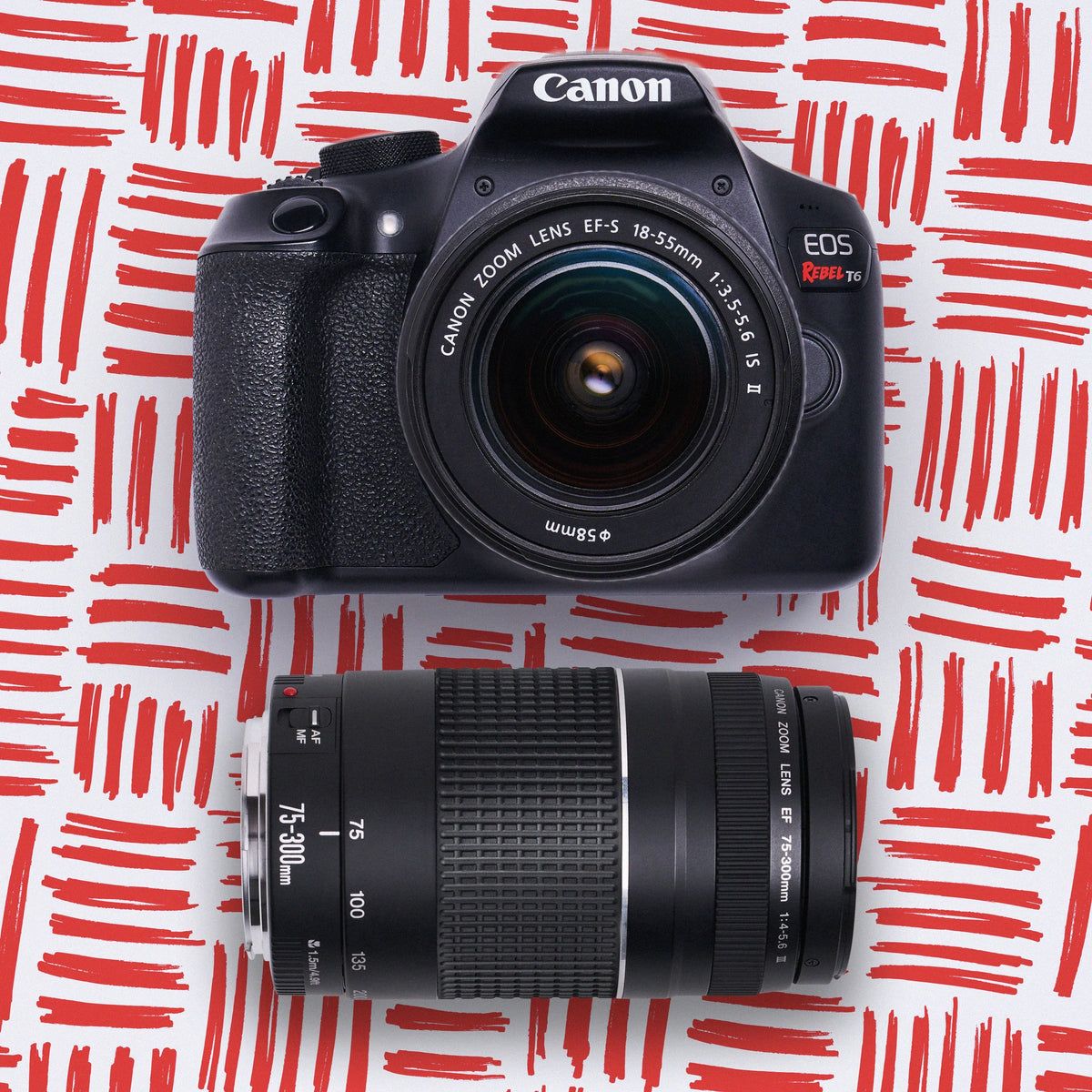 Canon DSLR camera with lens on a red and white patterned background