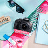 Restored Canon Rebel T7 styled with colorful accessories, labeled Born in 2018, Restored in 2026