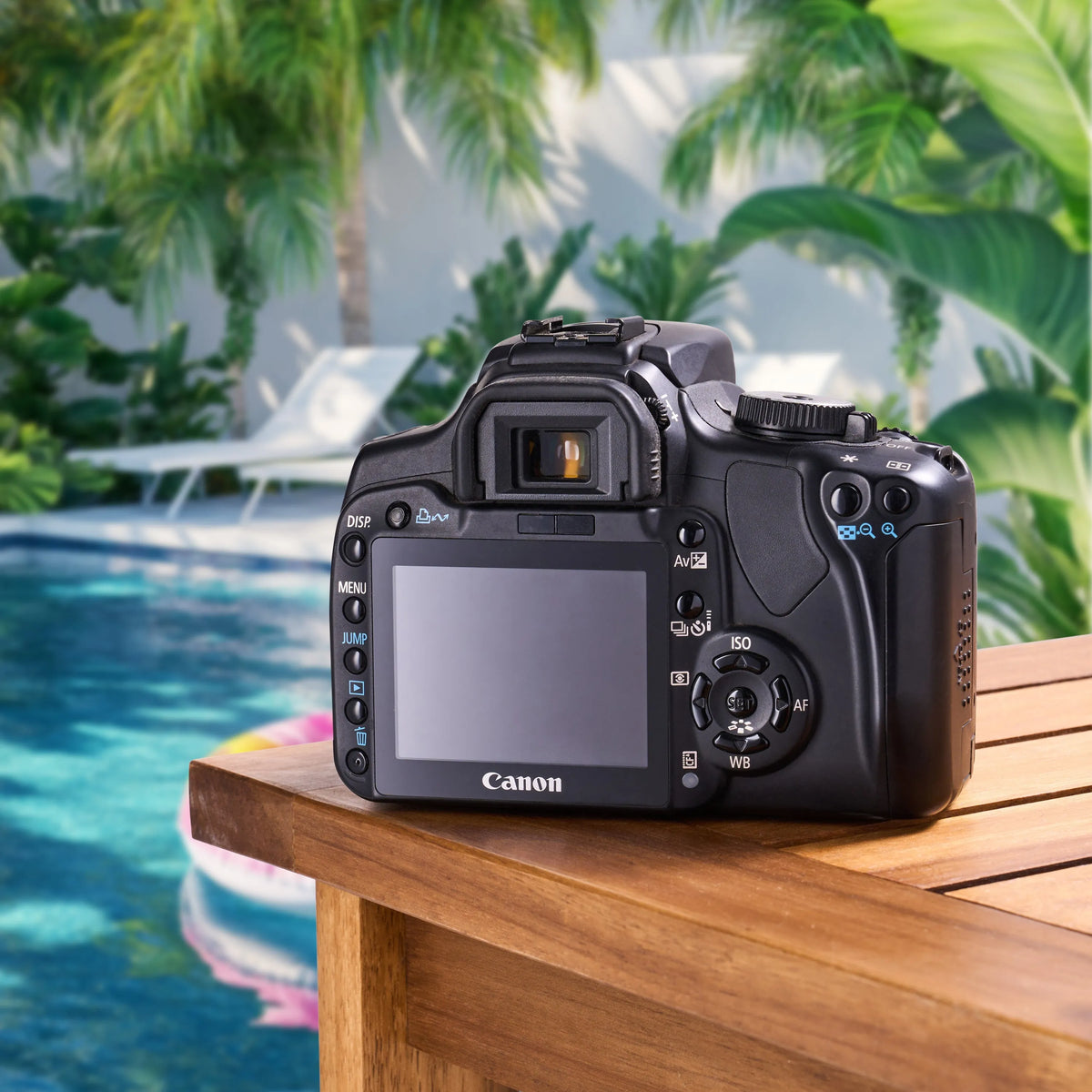 Back view of the Canon Rebel XTi showing its LCD screen and controls beside a swimming pool