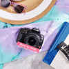 Restored Canon Rebel XTi styled with a sun hat and sunglasses, labeled Born in 2006, Restored in 2026