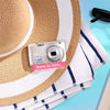 Restored Nikon COOLPIX S3100 styled with poolside accessories, labeled Born in 2011, Restored in 2026