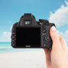 Back view of a Nikon D3100 DSLR showing its LCD screen and controls at the beach