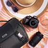 Nikon D3400 DSLR travel kit styled with a camera bag, two lenses and summer accessories