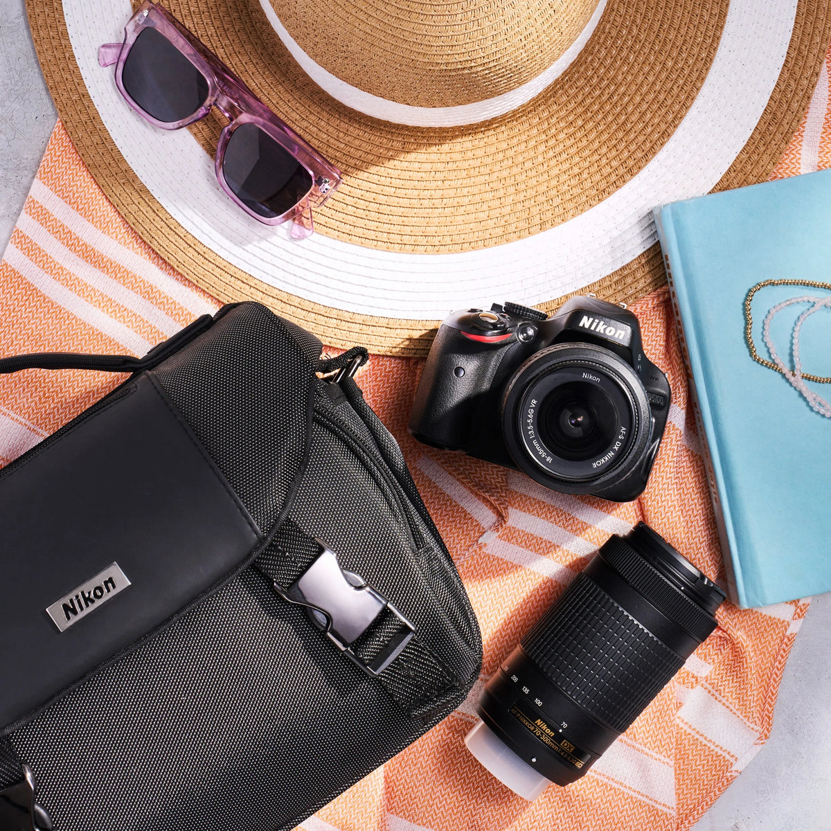 Nikon D5100 dual-lens kit with camera bag, DSLR body, two lenses, hat and sunglasses