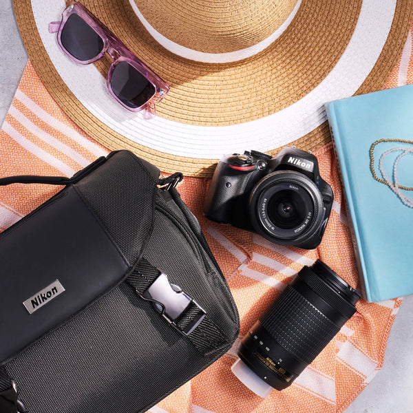Nikon D5100 dual-lens kit with camera bag, DSLR body, two lenses, hat and sunglasses