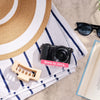 Restored Sony a5100 styled with a sun hat and sunglasses, labeled Born in 2014, Restored in 2026