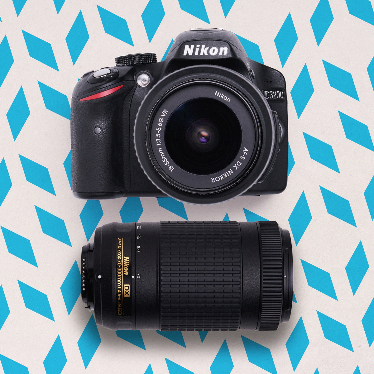 Nikon D3200 DSLR Camera with lens on a blue and white patterned background