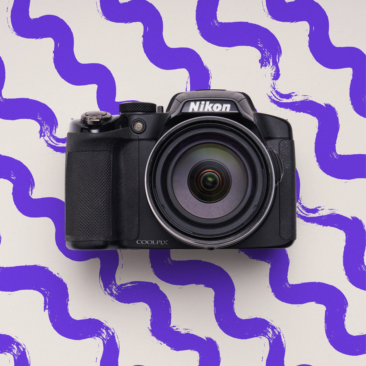 Front view of a restored Nikon COOLPIX B500 bridge camera on a purple-and-white patterned background