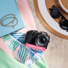 Restored Nikon COOLPIX B500 styled with a sun hat and sunglasses, labeled Born in 2016, Restored in 2026