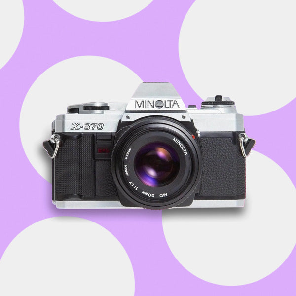 Minolta X-370 35mm film camera on a polka dot background