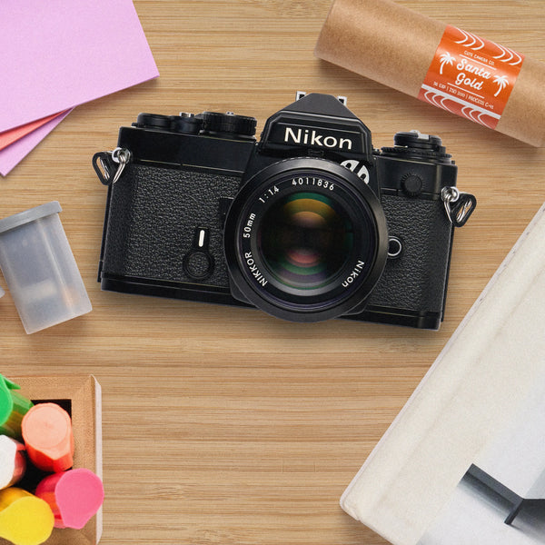 black nikon FE on a table 