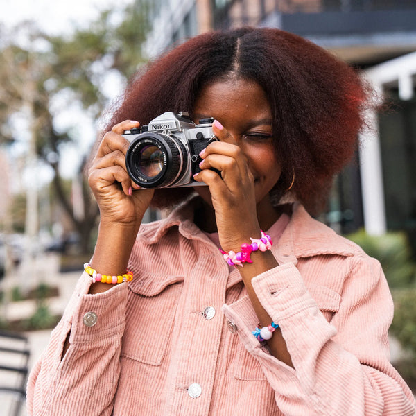 woman using a Nikon FE 35mm Film Camera
