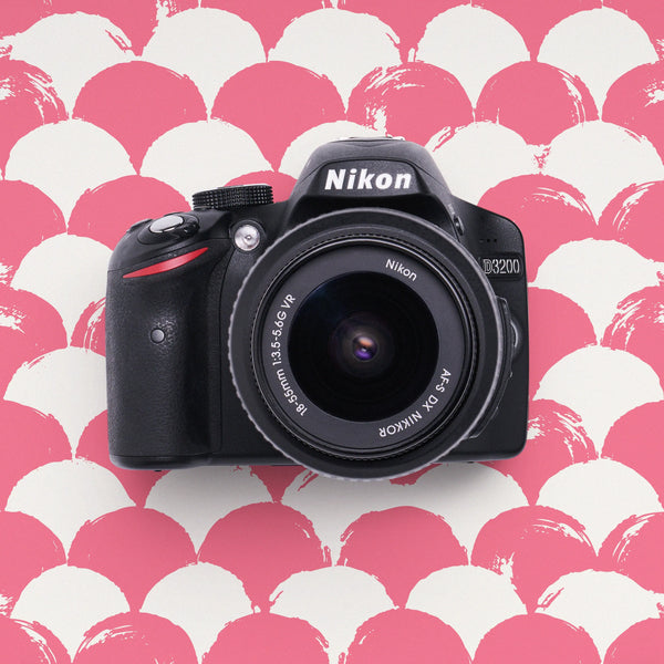 Nikon D3200 DSLR Camera on a pink and white patterned background