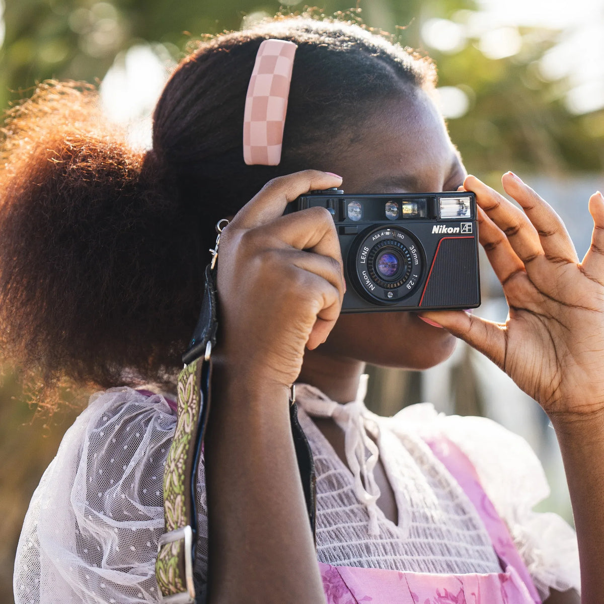 woman using the Nikon L35AF 35mm Point and Shoot Camera