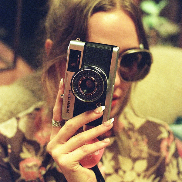 woman with Olympus Trip 35 Point and Shoot Film Camera