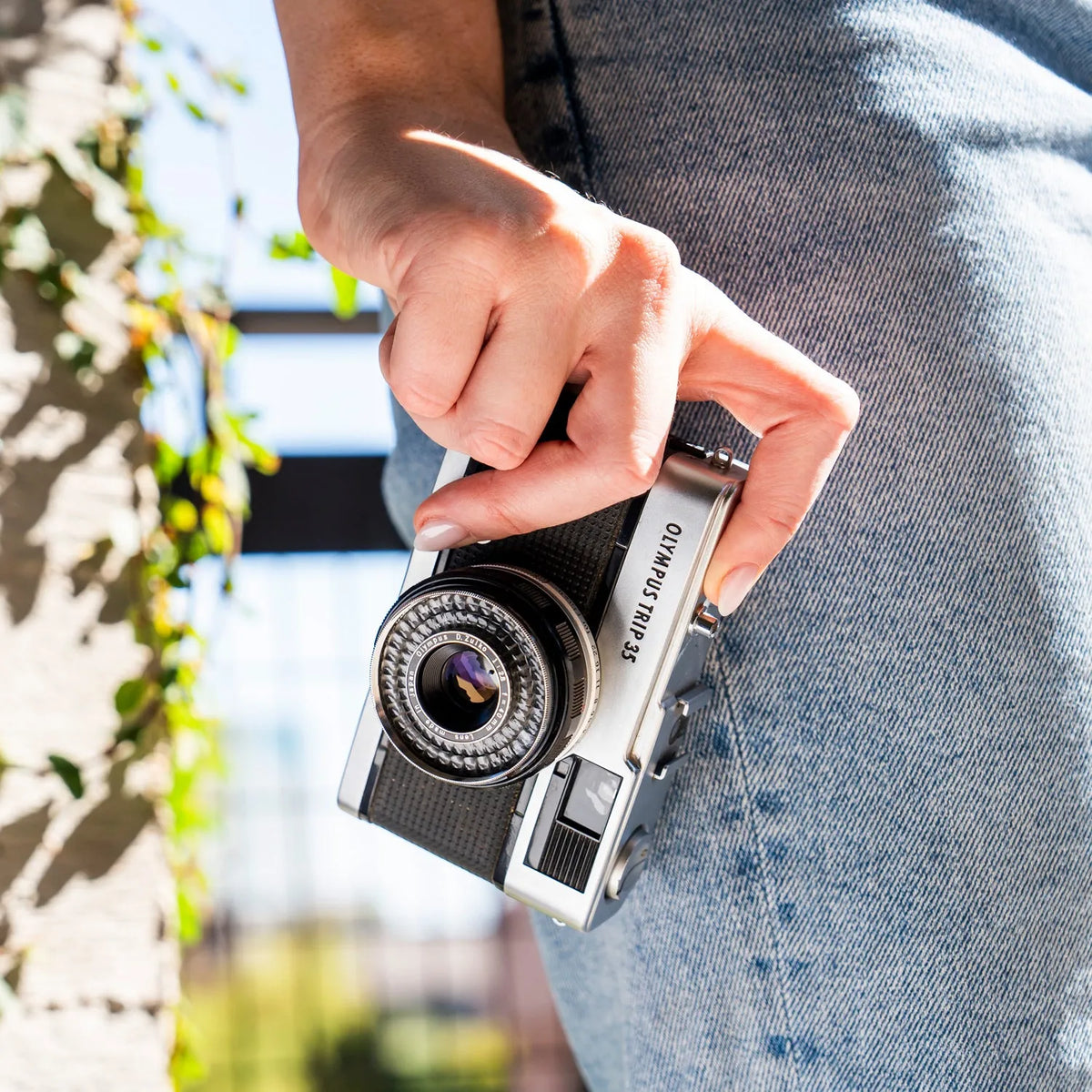 woman holding the Olympus Trip 35 Point and Shoot Film Camera