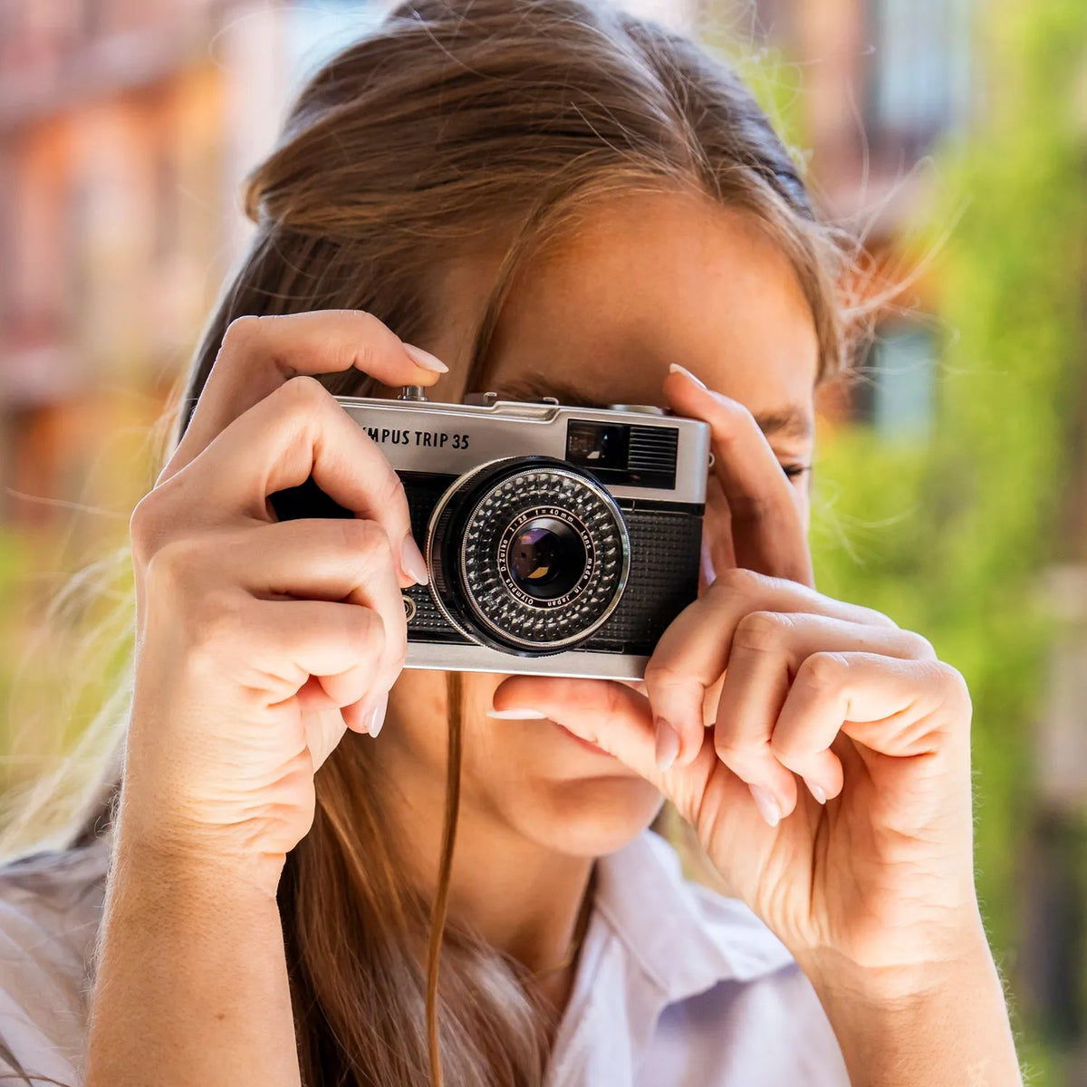 woman using the Olympus Trip 35 Point and Shoot Film Camera