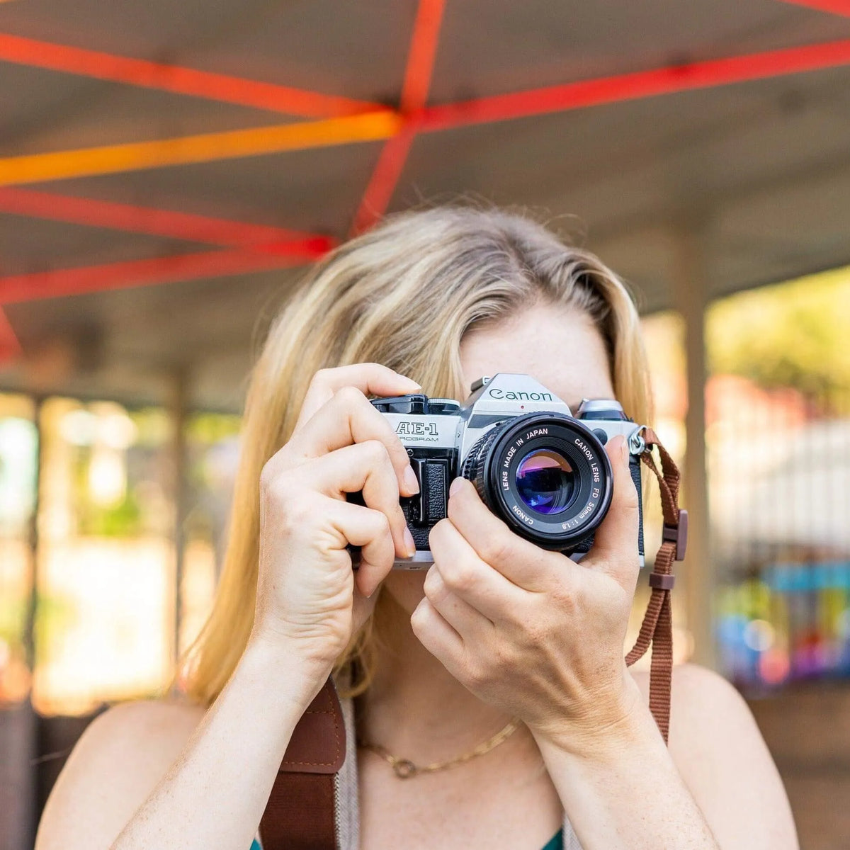 Photographer with Canon AE-1 Program 35mm SLR camera