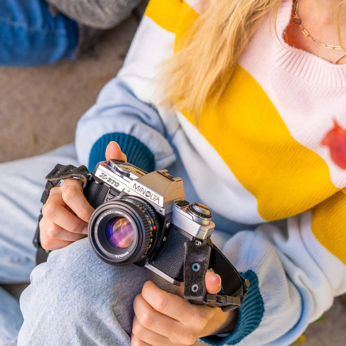 Girl holding the Minolta X-370 35mm film camera 