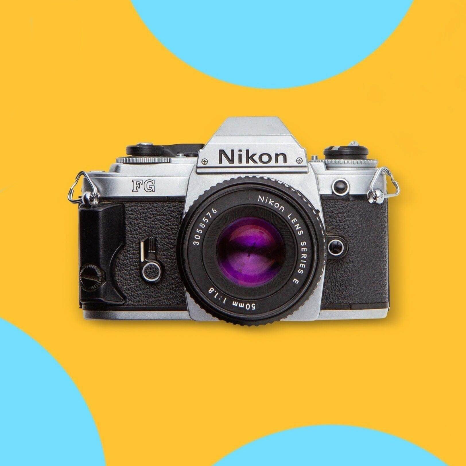 A vintage Nikon FG SLR film camera with a silver body and black textured grip, shown from the front with a 50mm lens. The camera is centered on a bright yellow background with abstract light blue circular shapes.