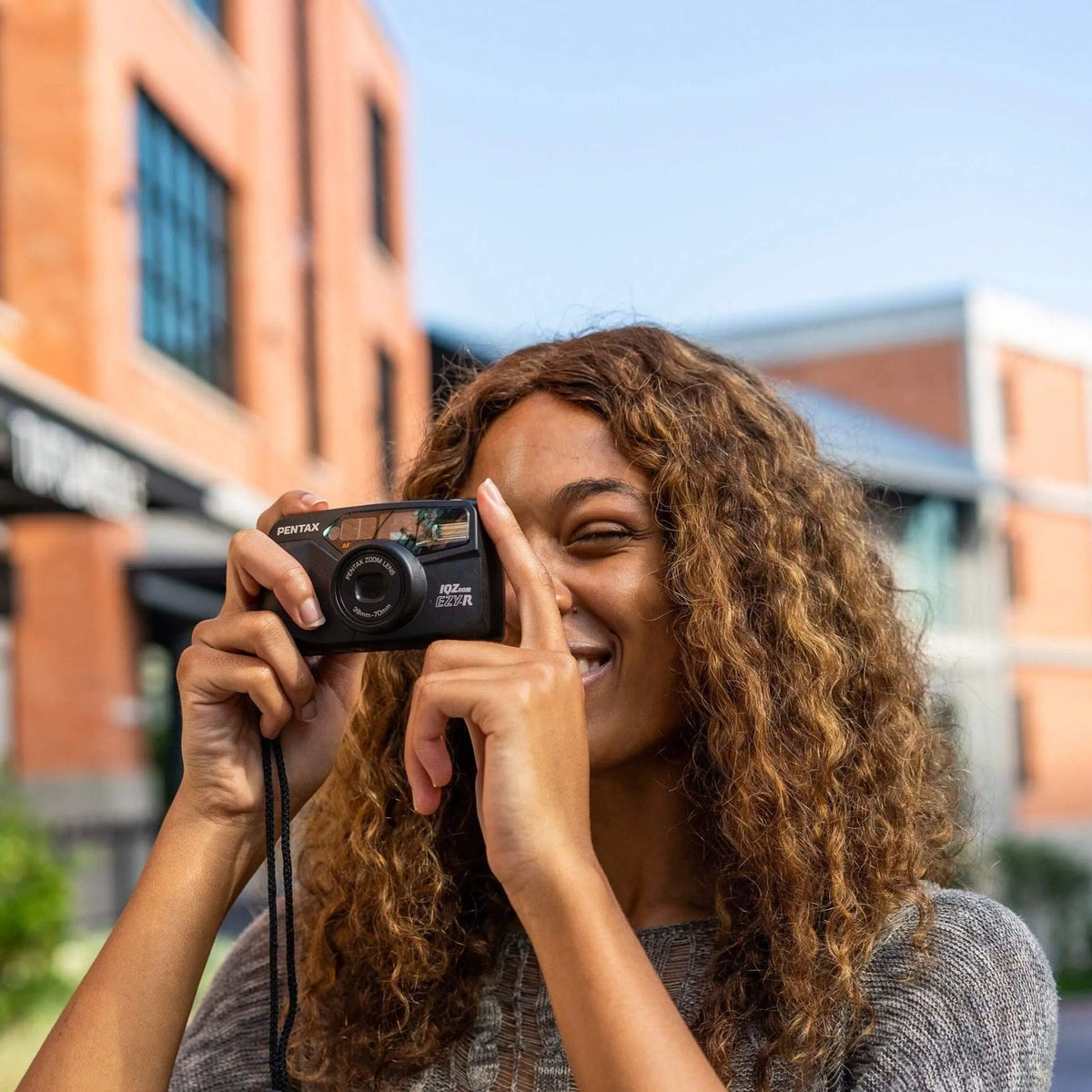 woman using the Pentax IQZoom EZY-R 35mm point-and-shoot film camera